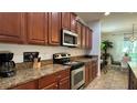 Modern kitchen featuring granite countertops and ample cabinetry at 8860 Candy Palm Rd, Kissimmee, FL 34747
