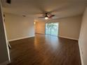 Bright living room with wood-look floors and sliding doors to balcony at 3045 Aaron Burr Ave # 10, Winter Park, FL 32792