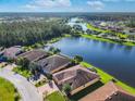 Aerial view of a house by a lake, showing its location within a residential development at 678 Irvine Ranch Rd, Kissimmee, FL 34759