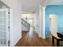 Bright entry hall with hardwood floors and staircase leading to the second floor at 307 Norfolk St, Celebration, FL 34747