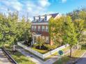 Two-story brick home with white picket fence and landscaping at 307 Norfolk St, Celebration, FL 34747