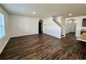 Spacious living room with dark hardwood floors and an arched entryway at 1823 Veterans Dr, Kissimmee, FL 34744