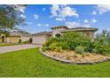 House exterior showcasing landscaping and a two-car garage at 795 Aviara Ln, Kissimmee, FL 34759