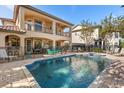 Luxury home with a large pool, spa, and patio furniture at 7435 Gathering Ct, Reunion, FL 34747