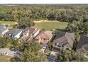 Luxury homes with tile roofs situated on a golf course at 7435 Gathering Ct, Reunion, FL 34747