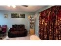 Living room featuring a brown recliner and decorative accents at 2440 Summerfield Way, Kissimmee, FL 34741