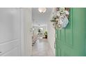 Interior view of entryway with green door and view to living area at 9824 Red Eagle Dr, Orlando, FL 32825