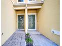 View of two townhome entryways with brick pavers at 9824 Red Eagle Dr, Orlando, FL 32825
