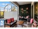 Relaxing pool area with covered patio, comfortable seating and a lush green wall at 434 Captiva Dr, Davenport, FL 33896