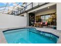Private pool with covered patio and comfortable seating area at 434 Captiva Dr, Davenport, FL 33896