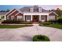 Elegant brick home with a classic design and manicured lawn at 2780 Vickie Ct, Kissimmee, FL 34744