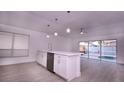 Modern kitchen with white cabinets, quartz countertops, and island at 8815 Parliament Ct, Kissimmee, FL 34747