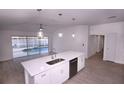 Modern kitchen with island, stainless steel appliances, and pool view at 8815 Parliament Ct, Kissimmee, FL 34747