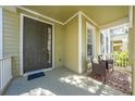 Inviting front porch with seating area, perfect for relaxing at 7127 Harmony Square S Dr # 7127, Harmony, FL 34773