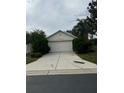 House exterior with a two-car garage and driveway at 2796 Whispering Trails Dr, Winter Haven, FL 33884