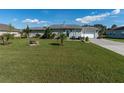 Single-story home with a lush lawn and a paved driveway at 1395 Emerald Dr, Kissimmee, FL 34744