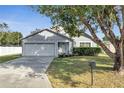 Two-story house with white garage door and landscaping at 613 Delaware Ave, Saint Cloud, FL 34769