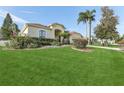 Single-Gathering home with lush landscaping and palm trees at 805 Via Bianca Dr, Davenport, FL 33896
