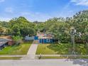 Aerial view of a charming blue house with a yard at 13 S Alden St, Kissimmee, FL 34741