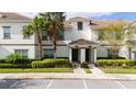Townhouse with mature landscaping and walkway at 8930 Stinger Dr, Davenport, FL 33896