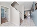 Open entryway with tile floors and views of stairs and living area at 8932 Stinger Dr, Davenport, FL 33896