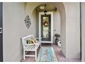 Inviting entryway with a bench, wreath, and decorative rug at 1703 Encinitas Way, Kissimmee, FL 34759