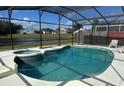 Inviting screened pool with a spa, overlooking a lake at 3018 Bransbury Ct, Kissimmee, FL 34747