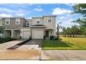 Two-story townhome with attached garage and front yard at 3550 Davenport Creek Ct, Kissimmee, FL 34746