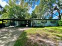 Ranch style home with carport and well-maintained lawn at 5312 Goddard Ave, Orlando, FL 32810