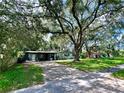 House with a large tree in front and a spacious lawn at 5312 Goddard Ave, Orlando, FL 32810