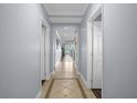 Bright hallway with tile flooring and access to rooms at 7662 Whisper Way # 402, Reunion, FL 34747