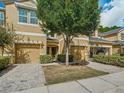 Tan two-story townhome with two-car garage at 8150 Serenity Spring Dr, Windermere, FL 34786