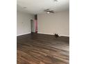 Spacious living area featuring wood-look flooring and a ceiling fan at 221 Elm Ct, Poinciana, FL 34759