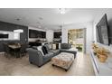 Open living room featuring a sectional sofa, dining area, and view to backyard at 15109 Willow Arbor Cir, Orlando, FL 32824