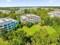 Aerial view of an apartment building and surrounding area at 7650 Whisper Way # 203, Reunion, FL 34747