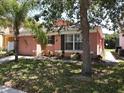 Charming light pink house with a two-car garage and well-manicured lawn at 270 Earlmont Pl, Davenport, FL 33896