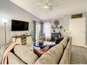 Bright living room featuring a sectional sofa, flat-screen TV and access to patio at 270 Earlmont Pl, Davenport, FL 33896