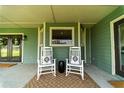 Relaxing back porch with rocking chairs and a view of the countryside at 4121 Albritton Rd, St Cloud, FL 34772