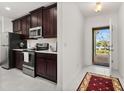 Modern kitchen with stainless steel appliances and dark wood cabinets at 4919 Conifer Cone Dr, Kissimmee, FL 34746