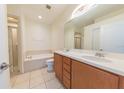 Clean bathroom with double vanity, soaking tub, and shower at 6364 Sedgeford Dr, Lakeland, FL 33811