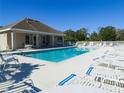 Community pool with lounge chairs and seating area at 6364 Sedgeford Dr, Lakeland, FL 33811