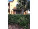 Townhome exterior featuring a double door entry and lush landscaping at 6560 Candied Peel Aly, Winter Garden, FL 34787