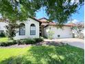 One-story home with white stucco and a terracotta tile roof at 9016 Murano Mews Ct, Kissimmee, FL 34747