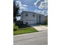Two-story house with attached garage and front yard at 255 Abbotsbury Dr, Kissimmee, FL 34758