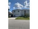 Two-story house with attached garage and front yard at 255 Abbotsbury Dr, Kissimmee, FL 34758