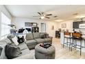 Open living room with sectional sofa and kitchen at 976 Leeward Pl # 102, Altamonte Springs, FL 32714
