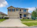 Two story house with tan exterior and brown shutters at 1927 Partin Terrace Rd, Kissimmee, FL 34744