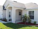 One-story house with covered porch and well-manicured landscaping at 236 Paradise Woods Ct, Davenport, FL 33896