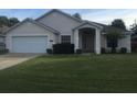 One-story house with attached garage and landscaped front yard at 236 Paradise Woods Ct, Davenport, FL 33896
