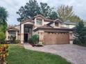 Two-story house with a brown garage door and landscaped yard at 325 Sonoma Valley Cir, Orlando, FL 32835